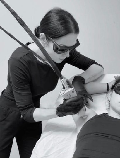 Nuderma aesthetician providing laser treatment