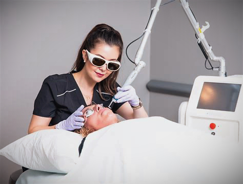 Laser facial treatment performed by a medical aesthetics provider